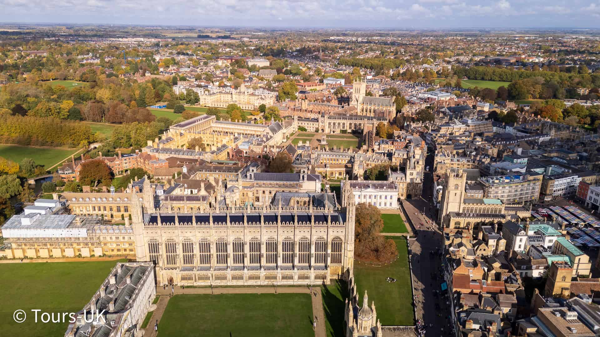 Luxury sightseeing bus tour view of Cambridge filmed from drone above the city