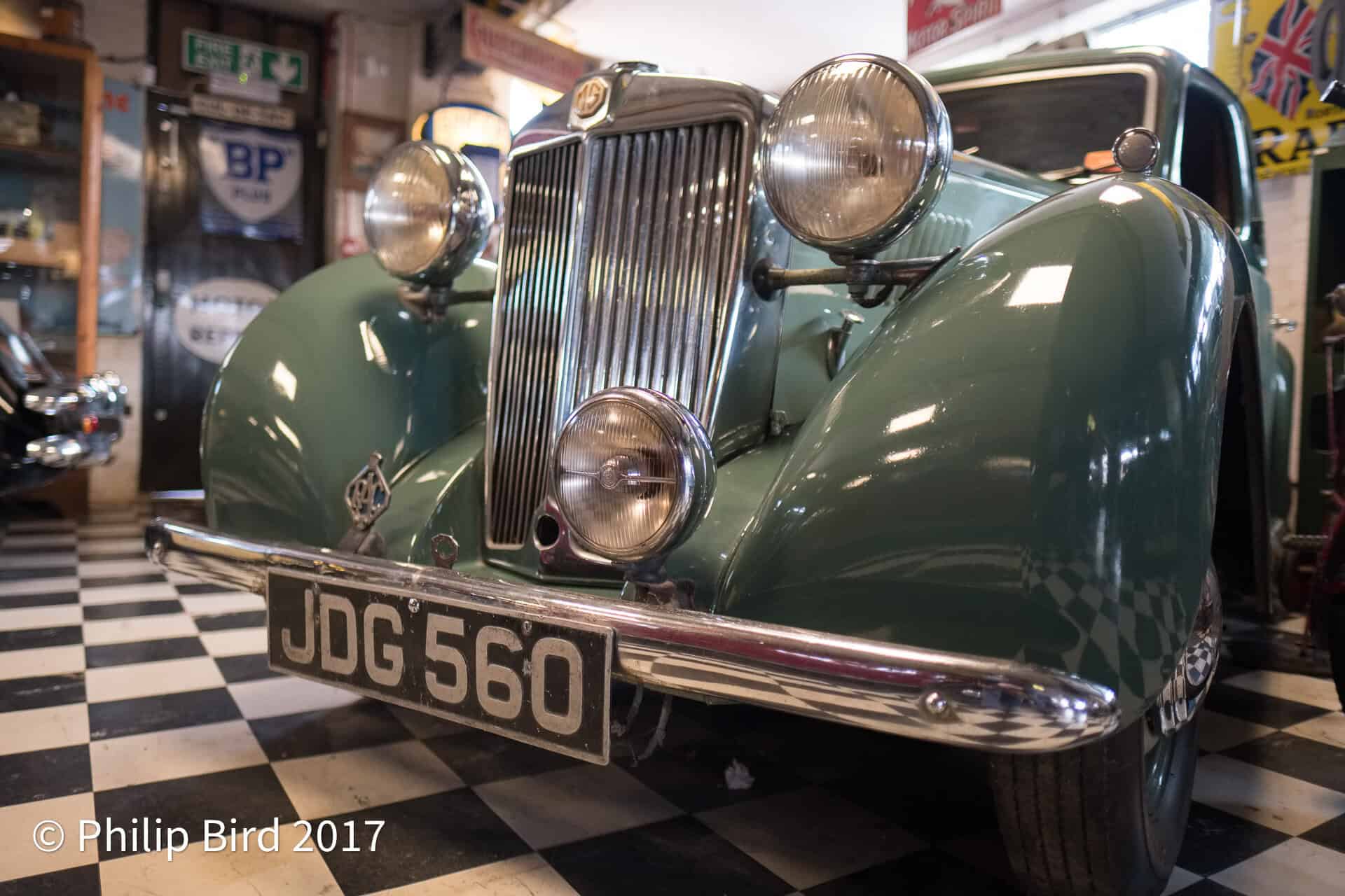 Old MG in the Motor Museum at Bourton-on-the-Water Vintage classic car in a garage with low lighting and retro decor, showcasing British automotive history and timeless design, perfect for car enthusiasts and vintage vehicle collectors.